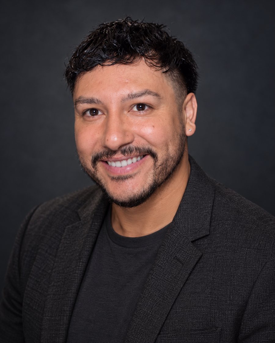 Diego Moreno smiling in a dark blazer